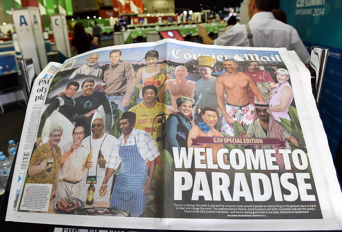 A wrap-around front-page of an Australian newspaper displayed in the media centre gives G20 leaders an irreverent welcome with Barack Obama depicted bare-chested and in swimming trunks, Angela Merkel hugging a koala and Vladimir Putin wearing a hat made from beer cartons, at the G20 Leader's Summit in Brisbane on November 14, 2014. Photo: AFP