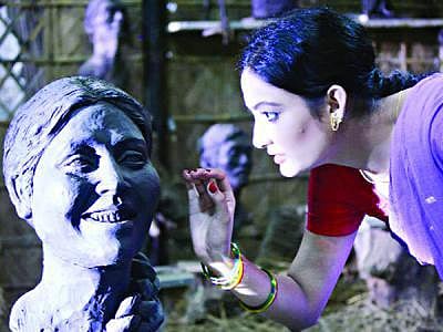 Actress Oporna is seen playing her role in the film 'Mrittika Maya'.