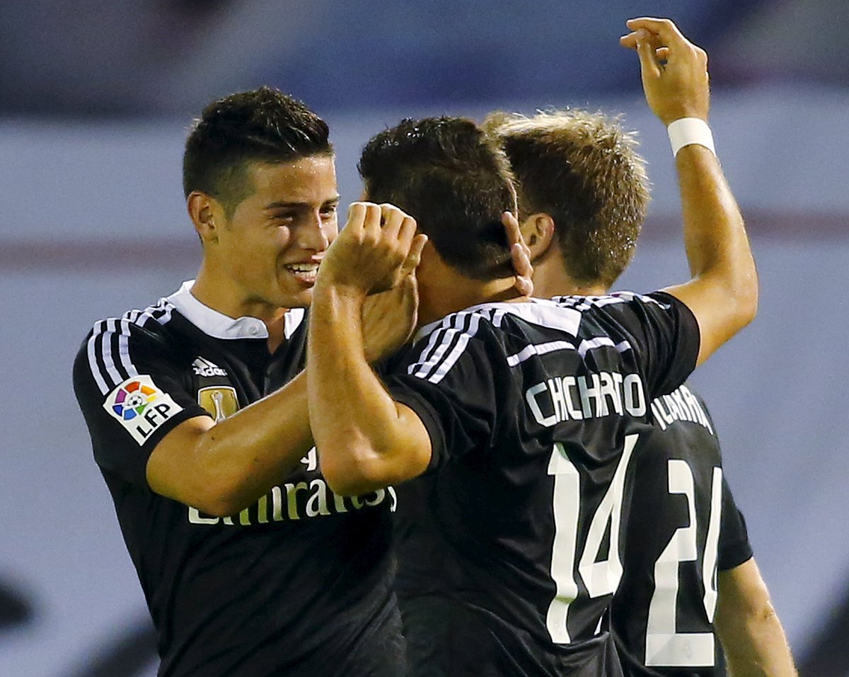 Real Madrid's Javier Hernandez 'Chicharito' (14) celebrates his goal against Celta Vigo with teammate James Rodriguez (L) during their Spanish first division soccer match at Balaidos stadium in Vigo April 26, 2015. REUTERS
