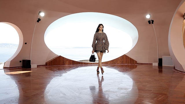 A model presents a creation by Belgian fashion designer Raf Simons during the Dior 2016 cruise collection show on May 11, 2015 at the Palais Bulle in Theoule-sur-Mer, southeastern France. Photo: AFP