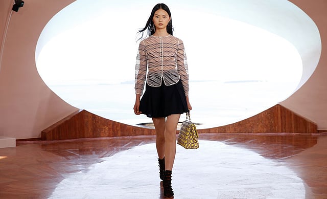 A model presents a creation by Belgian fashion designer Raf Simons during the Dior 2016 cruise collection show, on May 11, 2015 at the Palais Bulle in Theoule-sur-Mer, southeastern France. Photo: AFP