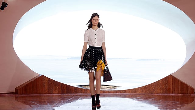 A model presents a creation by Belgian fashion designer Raf Simons during the Dior 2016 cruise collection show, on May 11, 2015 at the Palais Bulle in Theoule-sur-Mer, southeastern France. Photo: AFP