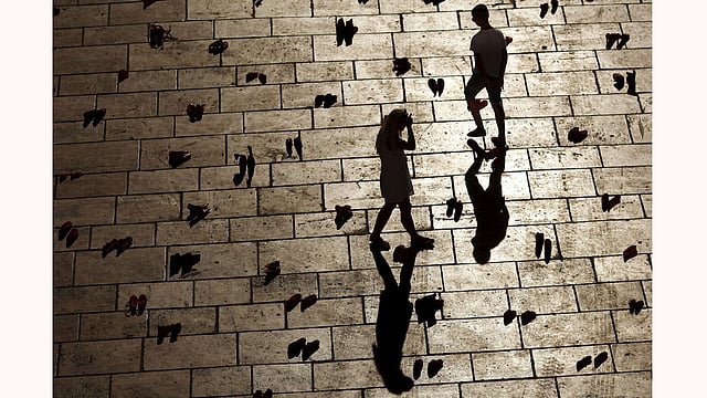 People walk amidst an art installation of 745 pairs of female red shoes, put on display by Mexican visual artist Elina Chauvet to protest against gender violence and femicide. Photo: Reuters