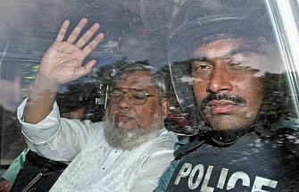 This file photo taken on July 17, 2013 shows secretary-general of Jamaat e Islam, Ali Ahsan Mohammad Mujahid (C), waving from a police vehicle as he is transported to the central jail following his court verdict in Dhaka. AFP file photo