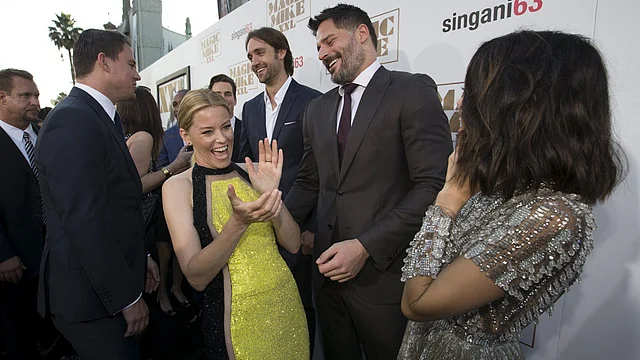 Cast members Elizabeth Banks laughs with co-star Joe Manganiello (2nd R), as co-star Channing Tatum (L) and his wife Jenna Dewan stand nearby, at the premiere of Magic Mike XXL in Hollywood, California