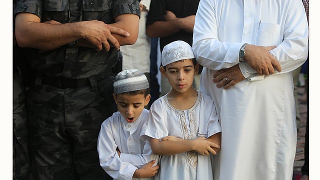 Palestinian Muslim boys attend the Eid al-Fitr prayer early on July 17, 2015. Photo: AFP
