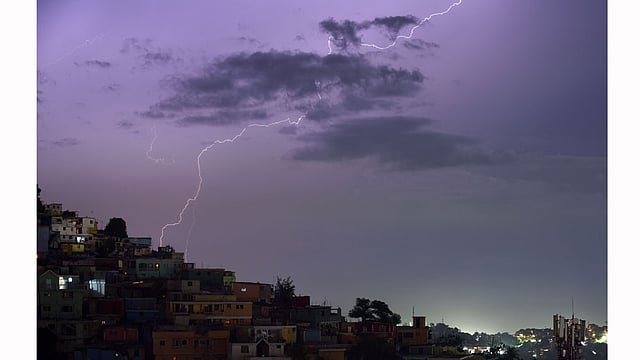 Flashes of lightning strike during an evening thunderstorm on August 13, 2015 in the Haitian capital Port-au-Prince. AFP