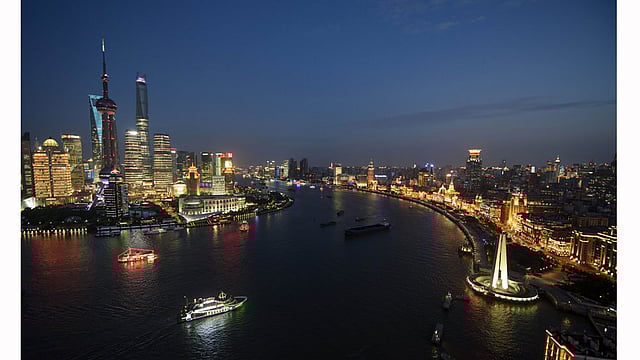Ships pass by the skyline of the Lujiazui Financial District in Pudong in Shanghai on August 14, 2015. Photo: AFP