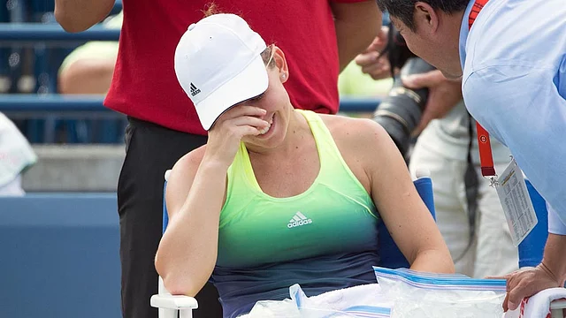 Simona Halep of Romania retires from the match during the third set against Belinda Bencic of Switzerland (not pictured) in the final match during the Rogers Cup tennis tournament on 16 August. Photo: Reuters