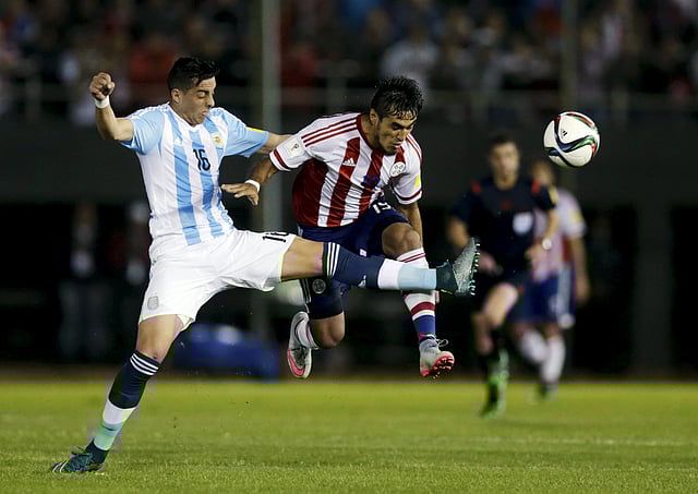 Argentina's Ramiro Funes Mori (L) fouls Paraguay's Dario Lezcano during their 2018 World Cup qualifying soccer match at the Defensores del Chaco stadium in Asuncion, Paraguay, October 13, 2015. REUTERS