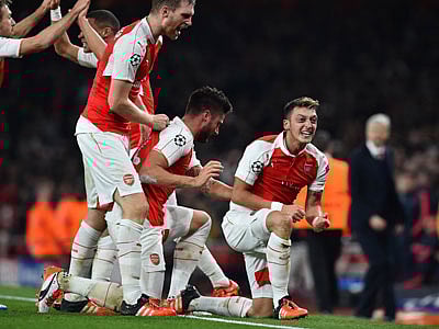 Arsenal’s German midfielder Mesut Ozil ® celebrates scoring his team’s second goal during the UEFA Champions League football match between Arsenal and Bayern Munich. Photo: AFP