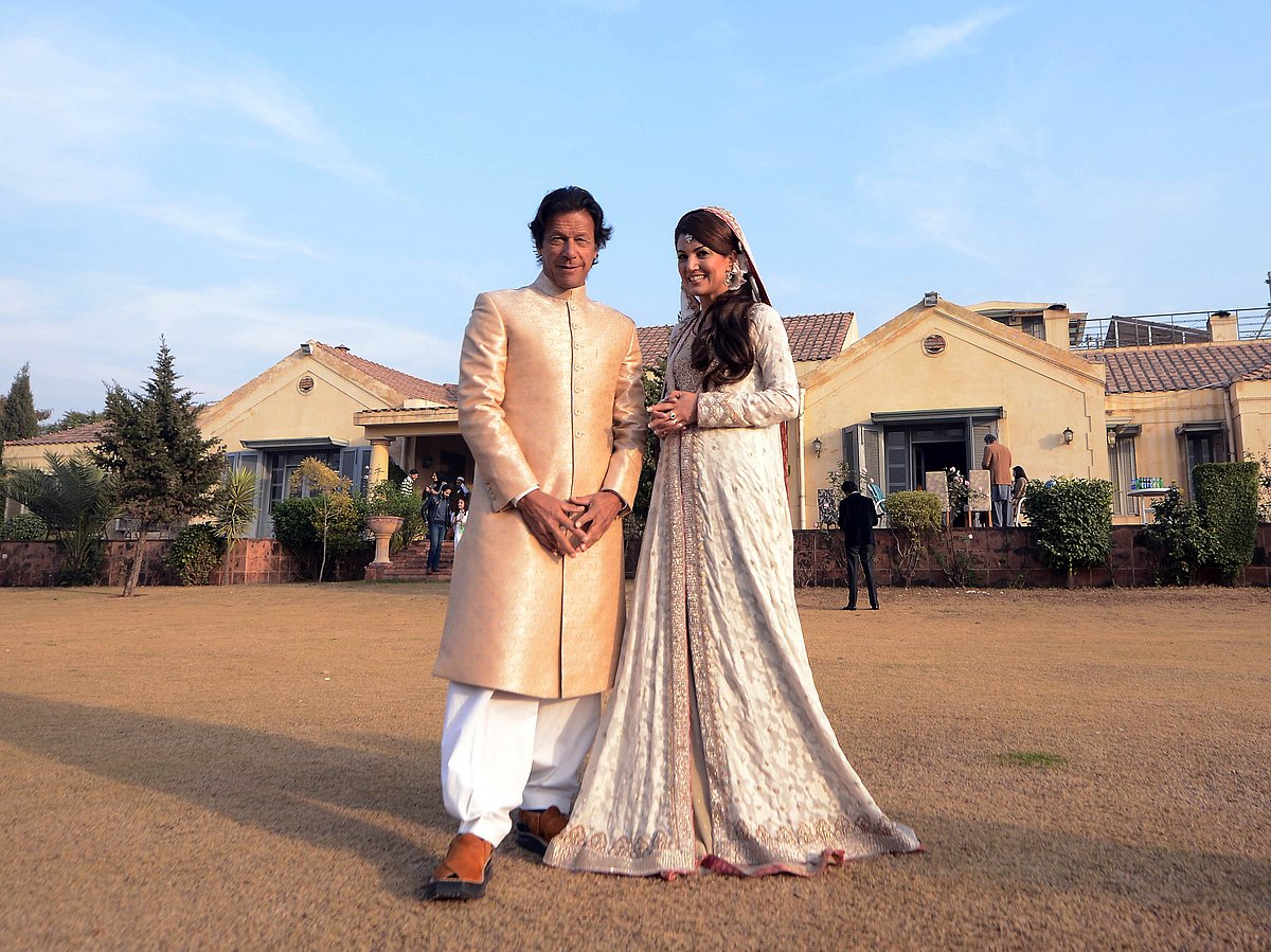In this handout photograph released by the Pakistan Tehreek Insaf (PTI) party on January 8, 2015, Pakistani opposition leader Imran Khan (L) and new wife Reham Khan pose for a photograph during their wedding ceremony at his house in Islamabad. AFP