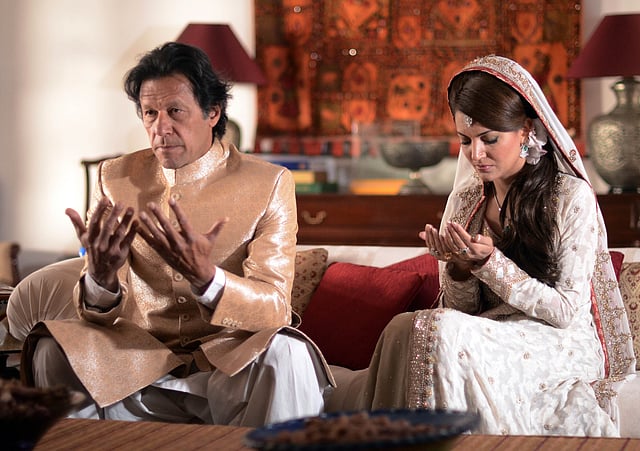 In this handout photograph released by the Pakistan Tehreek Insaf (PTI) party on 8 January, Pakistani opposition leader Imran Khan (L) and new wife Reham Khan pose for a photograph during their wedding ceremony at his house in Islamabad. Photo: AFP