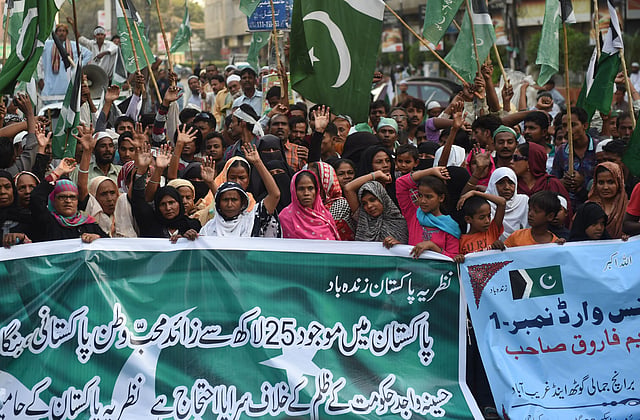 Activists from the Pakistan Muslim Alliance (PMA) carry a banner during a protest against the Bangladesh government over the execution of BNP leader Salahuddin Quader Chowdhury and Jamaat leader Ali Ahsan Mohammad Mojaheed, in Karachi on 22 November 2015. AFP