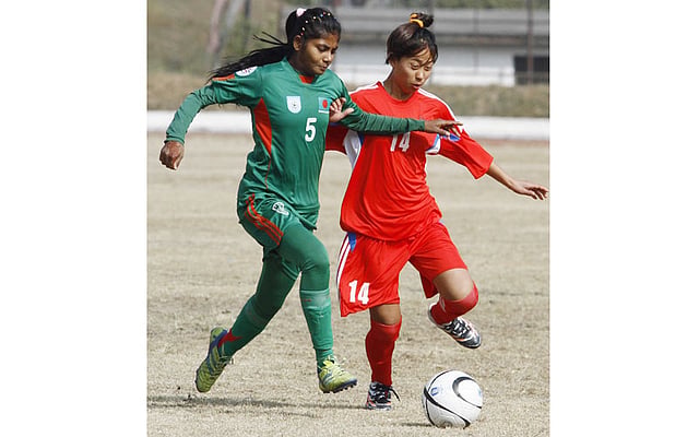 5.	Nepalese U-14 girls football player Manjali Kumari (R) and Bangladesh`s Nargis Khatun (L) tussle for the ball during the AFC regional championship match in Kathmandu on December 20, 2015. Bangladesh won 1-0. AFP