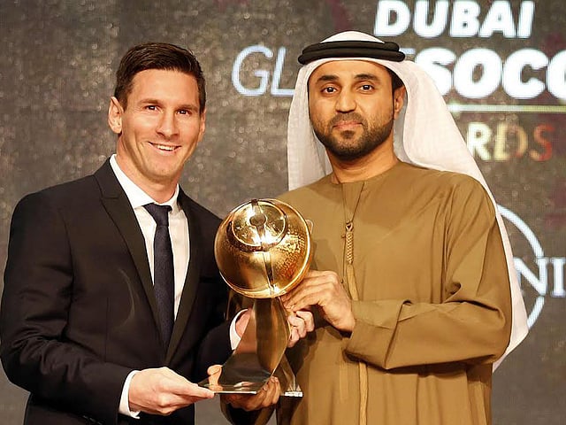 Handout photo shows Barcelona striker Lionel Messi (L) receiving the trophy for best player of the year during the Dubai Globe Soccer award at the end of the Dubai International Sports Conference. Photo: AFP