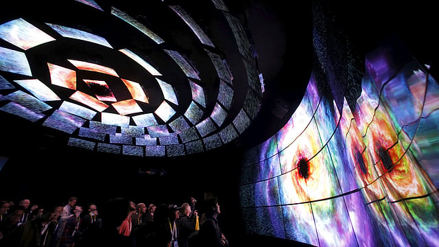 Attendees watch a display of 4K OLED televisions at the LG Electronics booth during the 2016 CES trade show in Las Vegas, Nevada January 7, 2016. Photo: Reuters