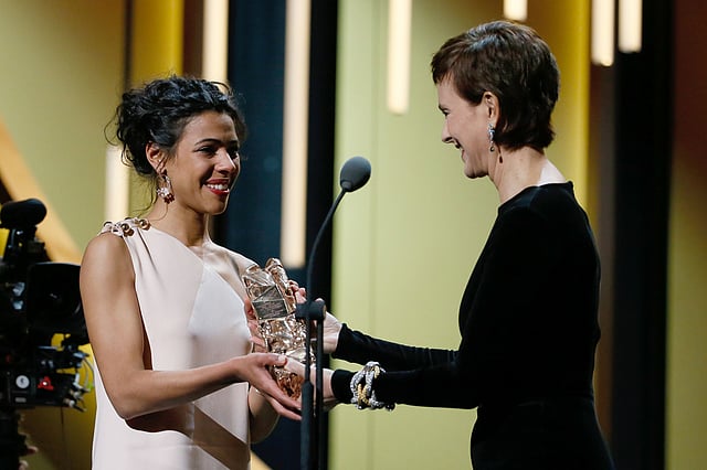 French actress Zita Hanrot (L) receives the Best Female Newcomer award for `Fatima` from French actress Carole Bouquet during the 41st edition of the Cesar Ceremony at the Theatre du Chatelet in Paris on 26 February. Photo: AFP