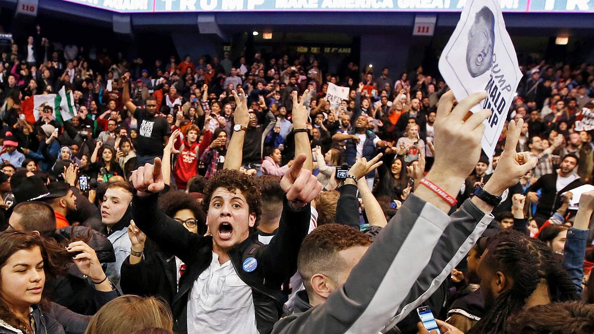 Demonstrators celebrate after Republican U.S. presidential candidate Donald Trump cancelled his rally at the University of Illinois in Chicago March 11, 2016. Reuters