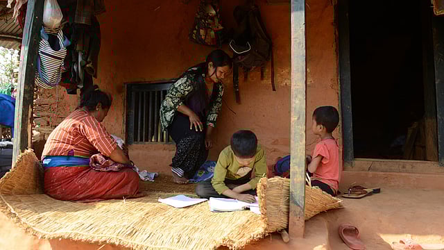 Nepalese migrant worker Sunita Magar (C), who was trafficked to Syria, working next to her mother (L), son Bipin Magar (2nd R) and daughter Elina Magar (R) at their house in Dhadhing district, some 100 kilometres west of Kathmandu. Photo: AFP