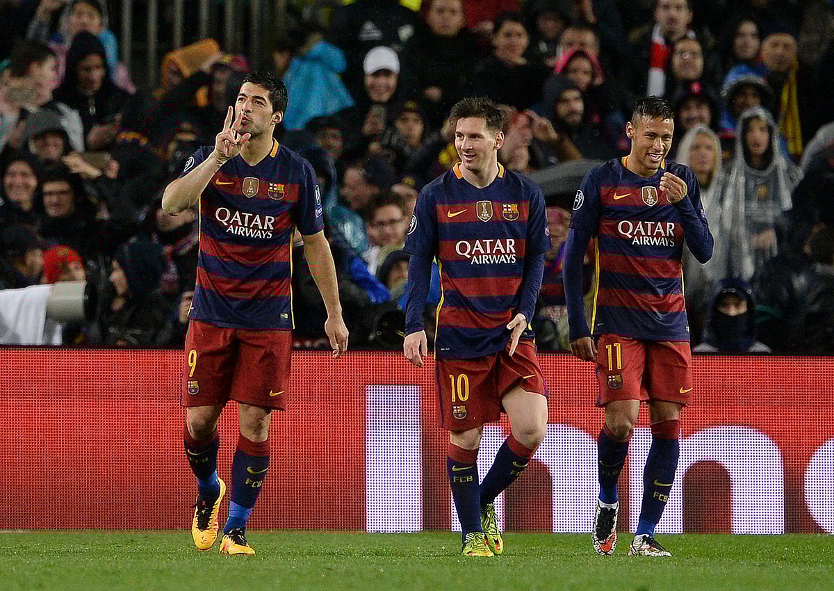 Barcelona's Uruguayan forward Luis Suarez (L) celebrates his goal with Barcelona's Argentinian forward Lionel Messi (C) and Barcelona's Brazilian forward Neymar (R) during the UEFA Champions League Round of 16 second leg football match FC Barcelona vs Arsenal FC at the Camp Nou stadium in Barcelona on March 16, 2016. AFP