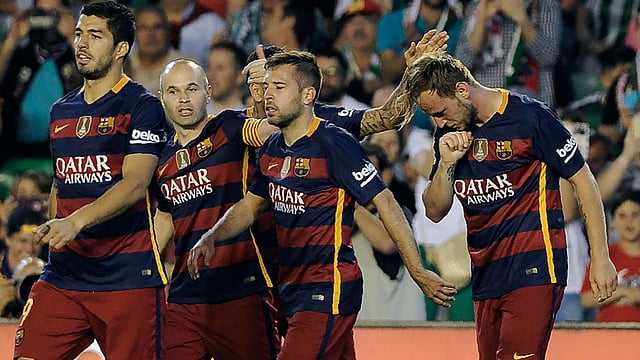 Barcelona`s Uruguayan forward Luis Suarez (L) and Barcelona`s midfielder Andres Iniesta (2nd L) walk with Barcelona`s Croatian midfielder Ivan Rakitic (R) AFP