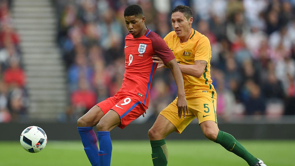 England’s striker Marcus Rashford (L) vies for the ball against Australia’s Mark Milligan during the friendly football match between England and Australia at the Stadium of Light in Sunderland, England. Photo: AFP