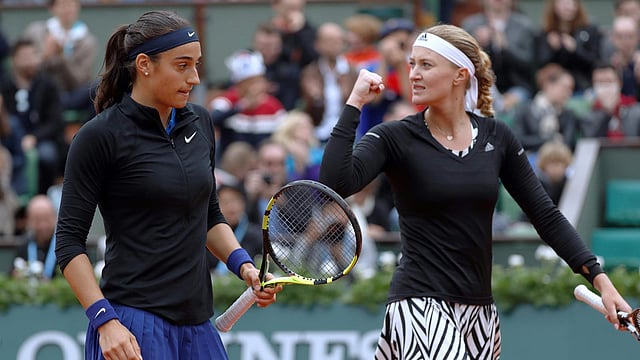 France`s Caroline Garcia (L) and France`s Kristina Mladenovic react during their women`s double final match against Russia`s Ekaterina Makarova and Russia`s Elena Vesnina at the Roland Garros 2016 French Tennis Open in Paris on June 5, 2016. Photo: AFP
