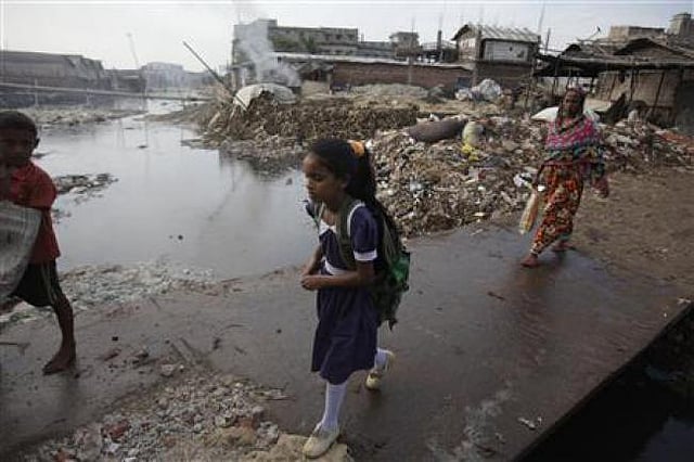 A schoolgirl crosses a bridge next to a tannery factory by the river Buriganga at Hazaribagh in Dhaka October 9, 2012. Reuters file photo