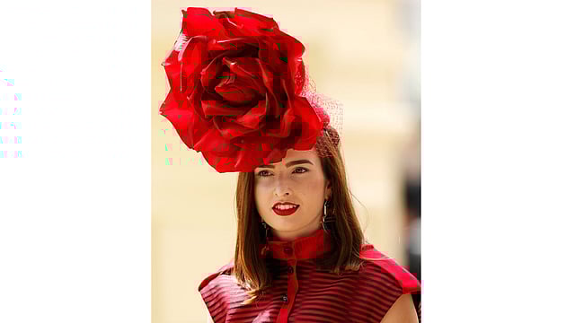 Ladies Day Racegoer wears hat. Photo: Reuters