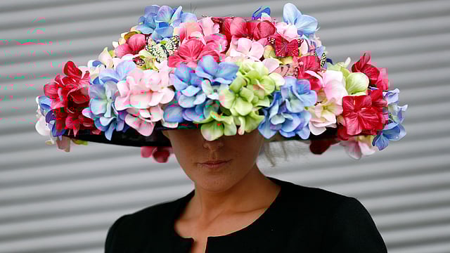 A racegoer poses on Investec Derby ladies day. Photo: Reuters