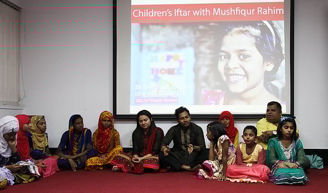 Bangladesh's test cricket captain Mushfiqur Rahim takes part at an iftar with a groups of unprivileged children on 25 June.