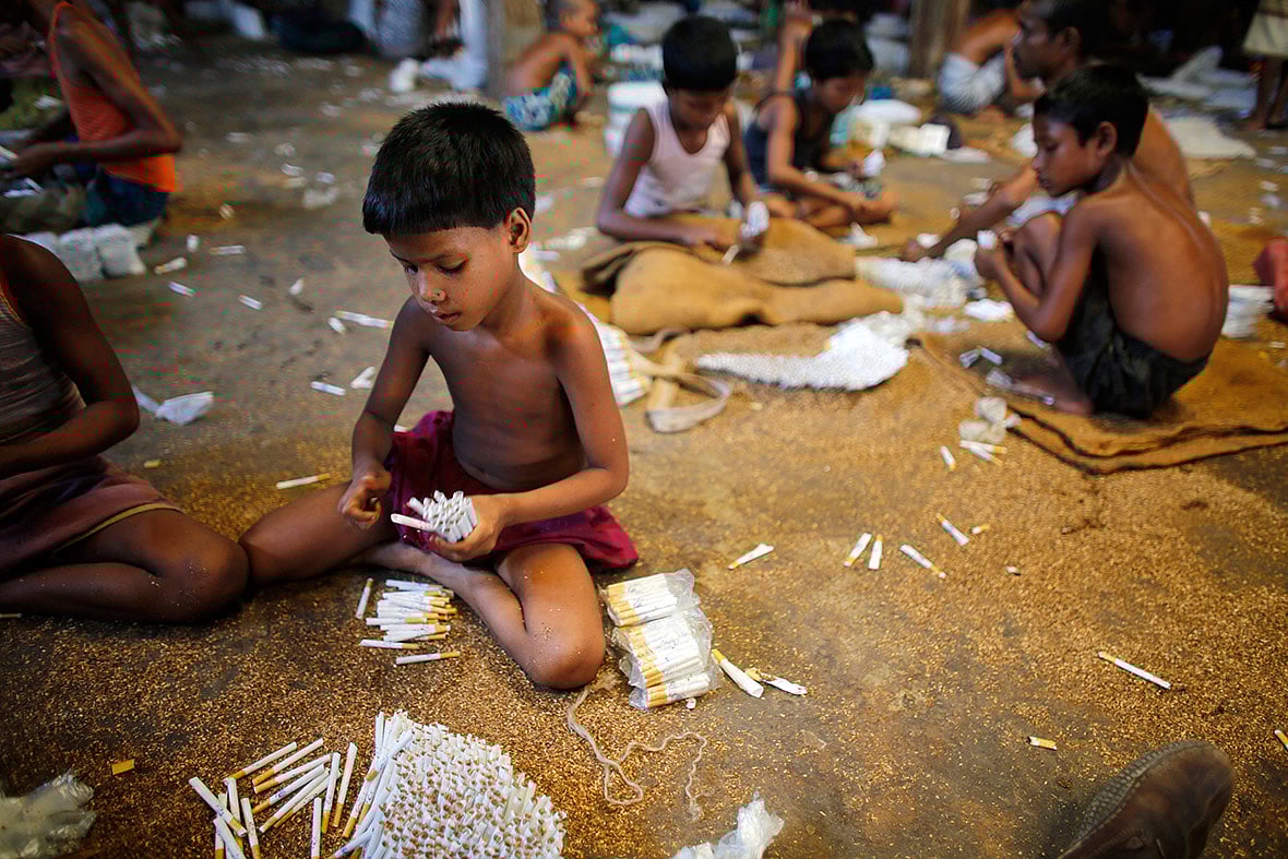 Children fill up empty cigarettes with locally grown tobacco in a factory at Haragach in Rangpur district, Bangladesh. Reuters file photo