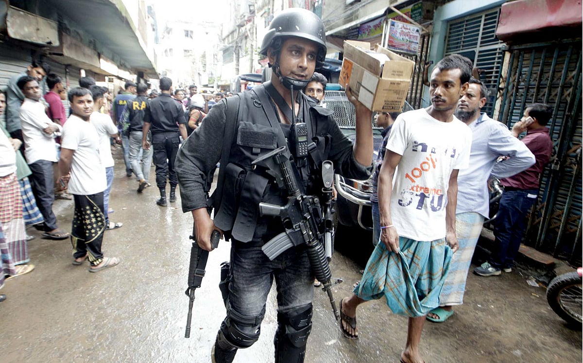 A SWAT member is seen in Kalyanpur area of the capital early morning on Tuesday. Photo : Sajid Hossain