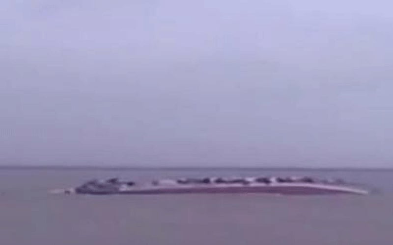 Capsized Pinak-6 is seen in the Padma River near Mawa Ghat in Lauhajang upazila of Munshiganj on Monday. TV grab