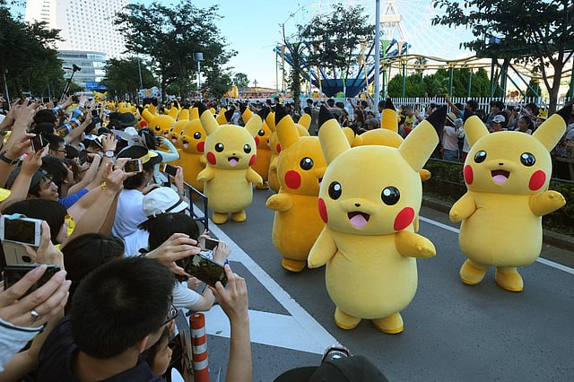 Performers dressed as Pikachu, the popular animation Pokemon series character, perform in the Pikachu parade in Yokohama on August 7, 2016. AFP