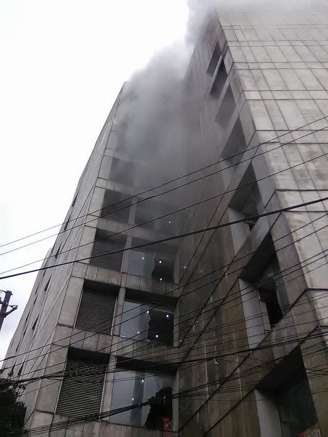 Smoke blows out from the Basundhara City shopping mall on 21 August, 2016. Photo: Apon Zahir