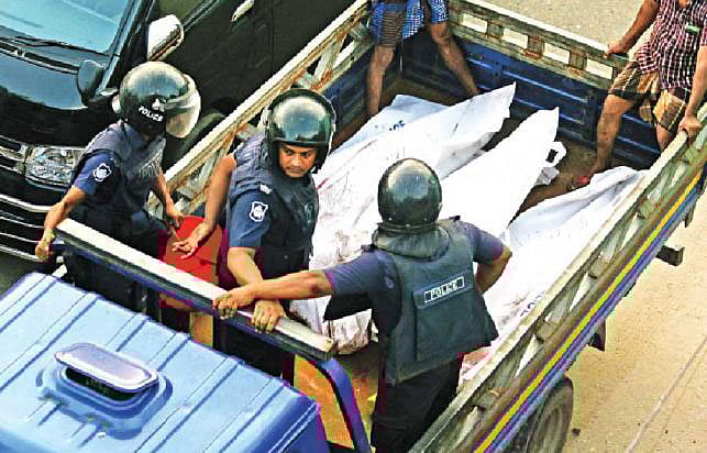 Members of police are taking away three bodies of the militants by a pick-up van. Photo: Prothom Alo