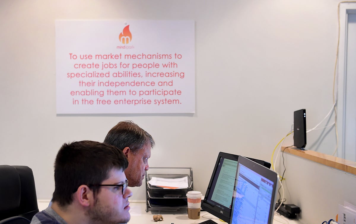 The team from Fox Networks group works at Mindspark on 24 August, 2016 in Santa Monica, California. MindSpark seeks out people on the high-functioning end of the autism spectrum with behaviors that, while at odds with social norms, are advantages in working with computer technology, according to co-founder Chad Hahn. Photo: AFP