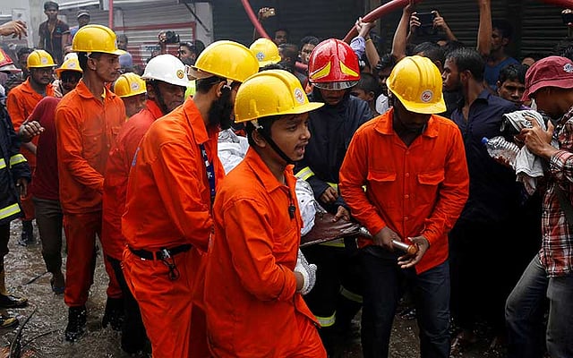 Rescue team members remove a dead body at a garment packaging factory after a fire broke out outside of Dhaka, Bangladesh, September 10, 2016. Photo: Reuters