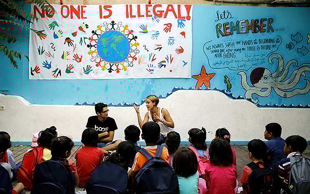 British volunteer primary school teacher Helen Brannigan speaks to refugee children before class at the volunteer-run `Refugee Education Chios` school on the island of Chios, Greece. Photo: Reuters