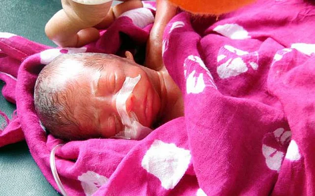 Six hours after a physician declared it dead, a newborn baby was found alive while being buried at Alipur graveyard of Faridpur on Thursday morning. Photo: Prothom Alo