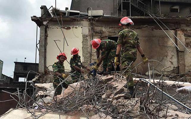 Army rescue team removing the rubble from the Tampaco site after the fire. Photo: Manirul Alam