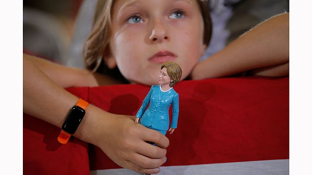 Nine-year-old Belle Shefrin holds a doll of US Democratic presidential nominee Hillary Clinton while listening to Hillary speak at a campaign rally in Akron, Ohio.  Photo: Reuters