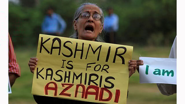 A woman holds a placard while shouting slogans during a protest to condemn violence in Kashmir, organised by Defence of Human Rights (DHR) in Islamabad, Pakistan. Photo: Reuters
