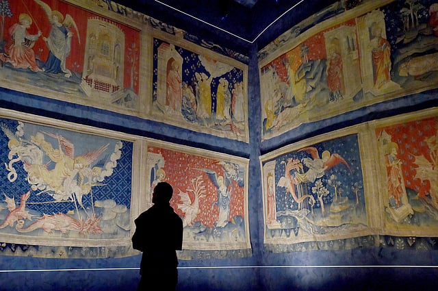 A visitor looks at the “Apocalypse Tapestry” (1377–1382), the world’s largest and oldest surviving medieval set of tapestries, at the Angers Castle in western France. Photo: AFP