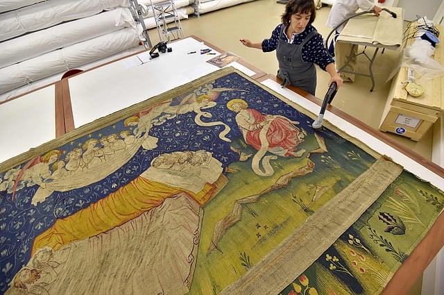 A woman restores a section of the “Apocalypse Tapestry” (1377–1382), the world’s largest and oldest surviving medieval set of tapestries, at the Angers Castle in western France. Photo: AFP
