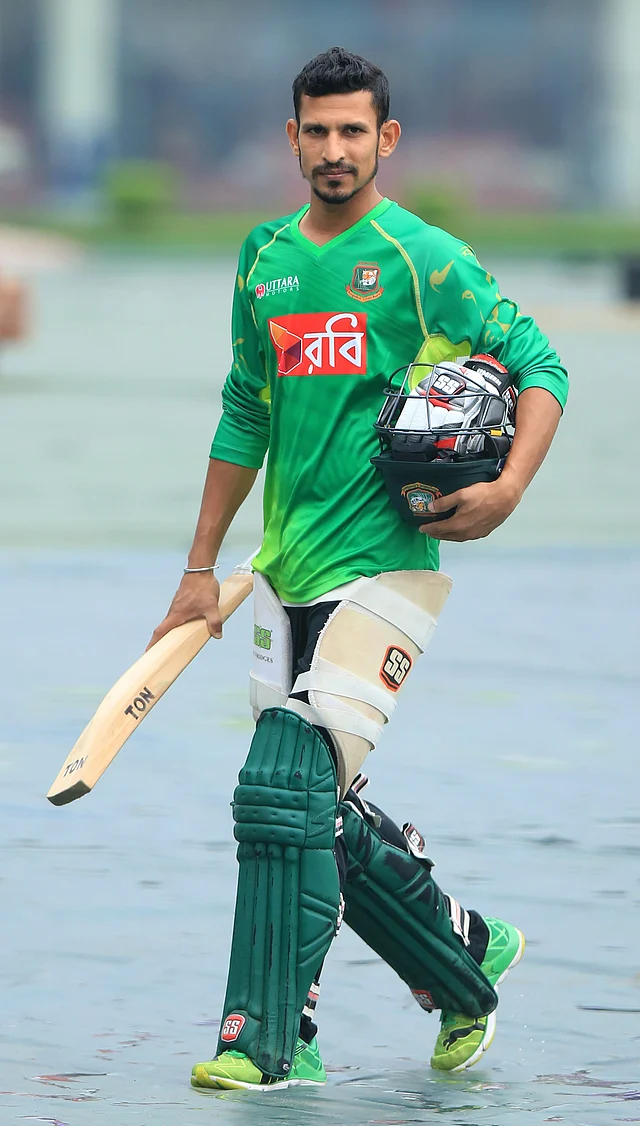 Bangladesh cricketer Nasir Hossain carries his equipment prior to an indoor practice session at the Sher-e-Bangla National Cricket Stadium in Dhaka on 6 October. Photo: AFP