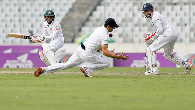 England`s captain Alastair Cook takes a catch to dismiss Bangaldesh`s captain Mohammad Rahim (L). Photo: Reuters