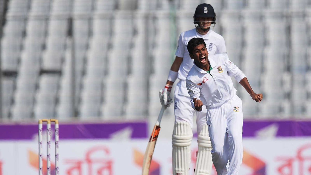 Mehedi Hasan celebrates after taking the wicket of England Moeen ALi as Joe Root look on during the second day of the second Test cricket match between Bangladesh and England at the Sher-e-Bangla National Cricket Stadium in Dhaka on 29 October. Photo: AFP